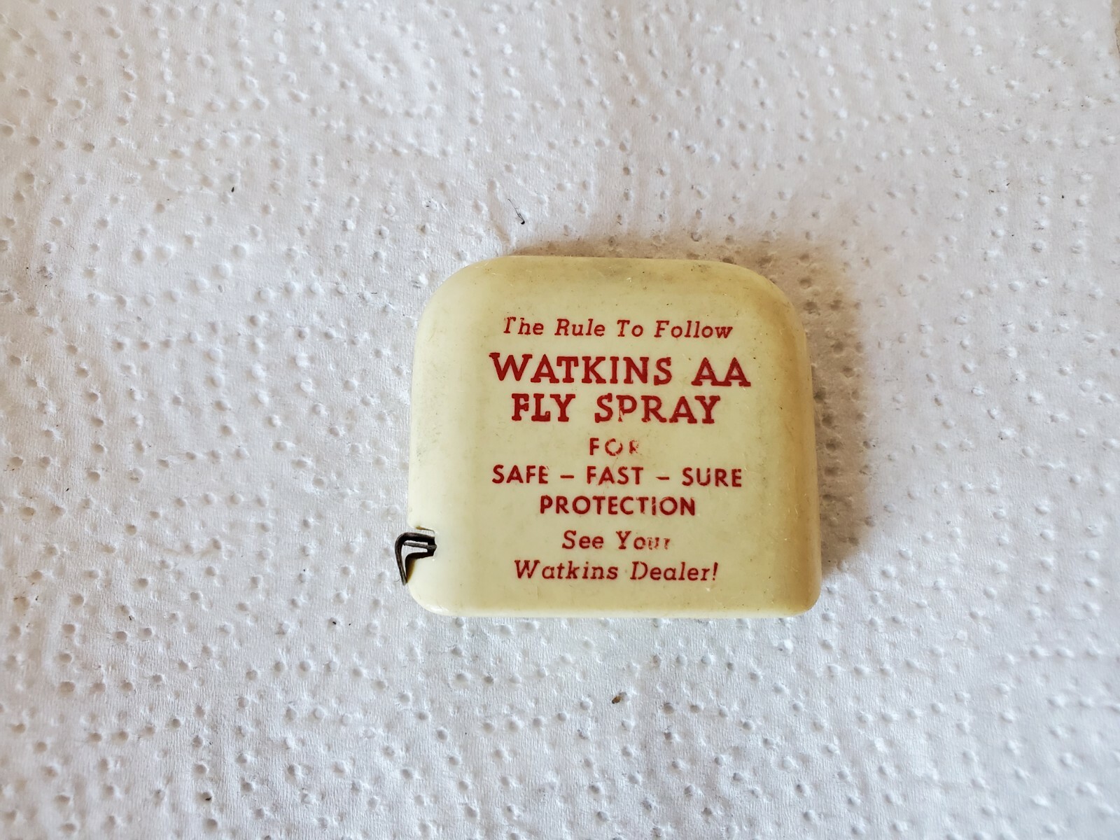 small plastic tape measure watkins AA fly spray see your watkins dealer