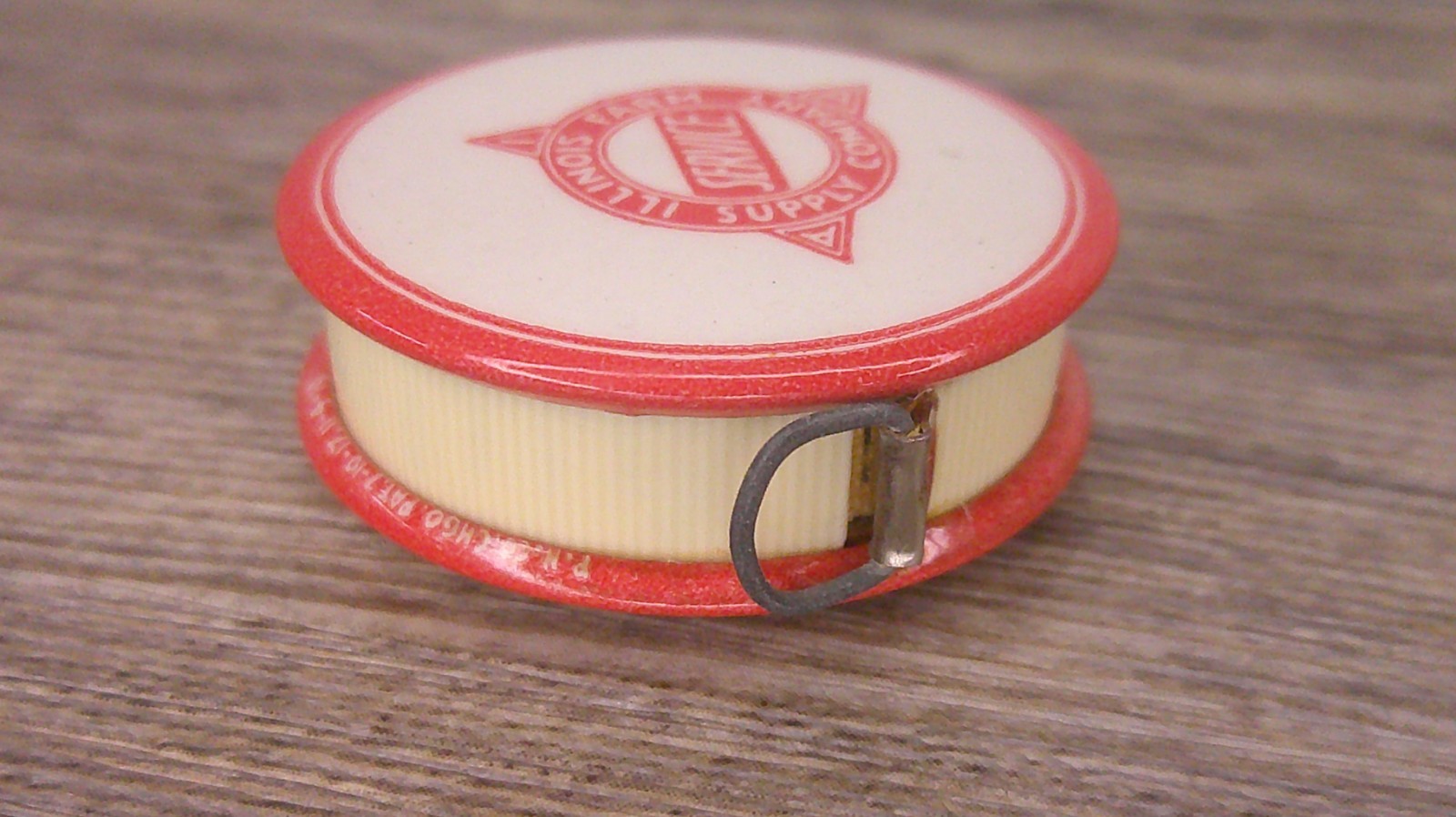 Illinois Farm supply co advertising celluloid tape measure has cloth tape works