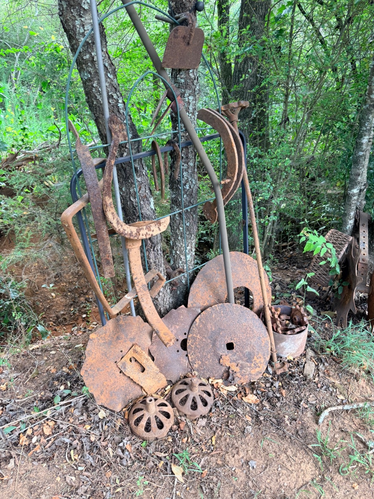 vintage farm implements equipment including horse shoes and an assortment of oth