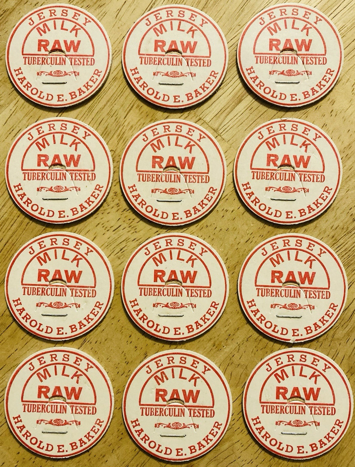 MILK BOTTLE CAP LOT OF (12)~HAROLD E. BAKER DAIRY, SHELBURNE FALLS, MASS.