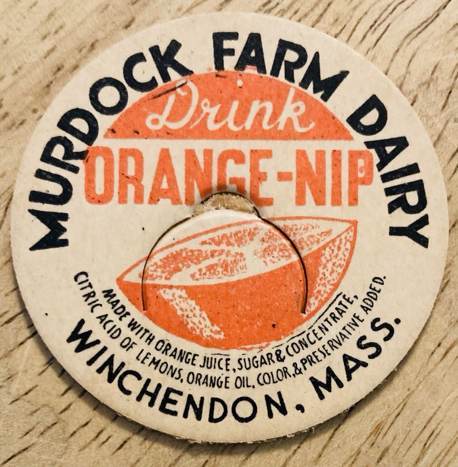 MILK BOTTLE CAP~MURDOCK FARM DAIRY, WINCHENDON, MASS. ORANGE-NIP DRINK
