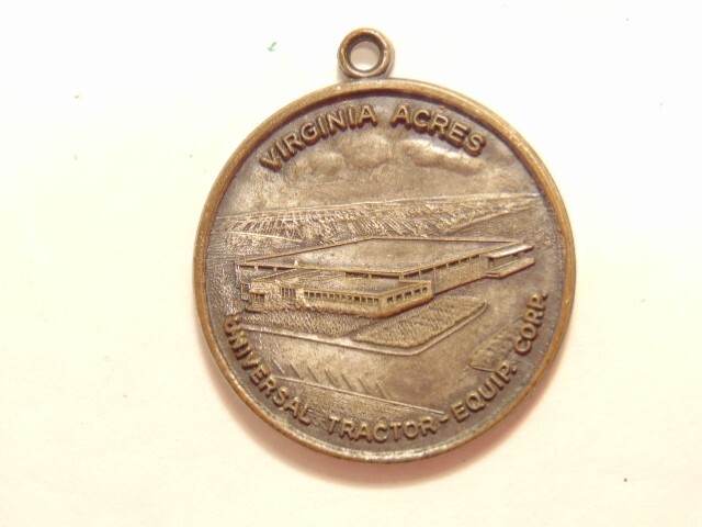 Universal Tractor Equipment Corp. 10th anniversary 1963 silver colored pendant