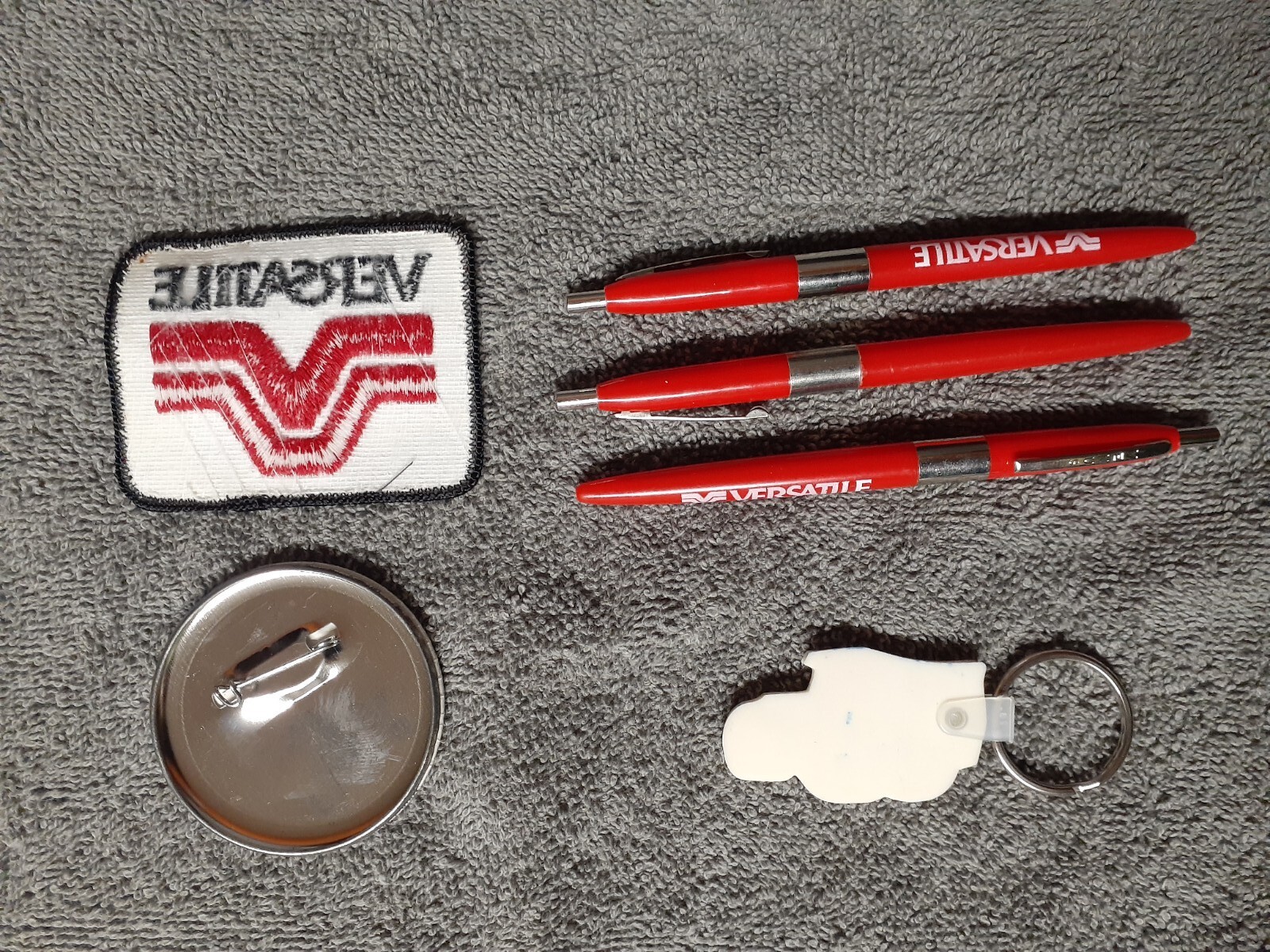 Versatile Tractor Collectibles – Iron-On Patch, Button Pin, Keychain and 3 Pens