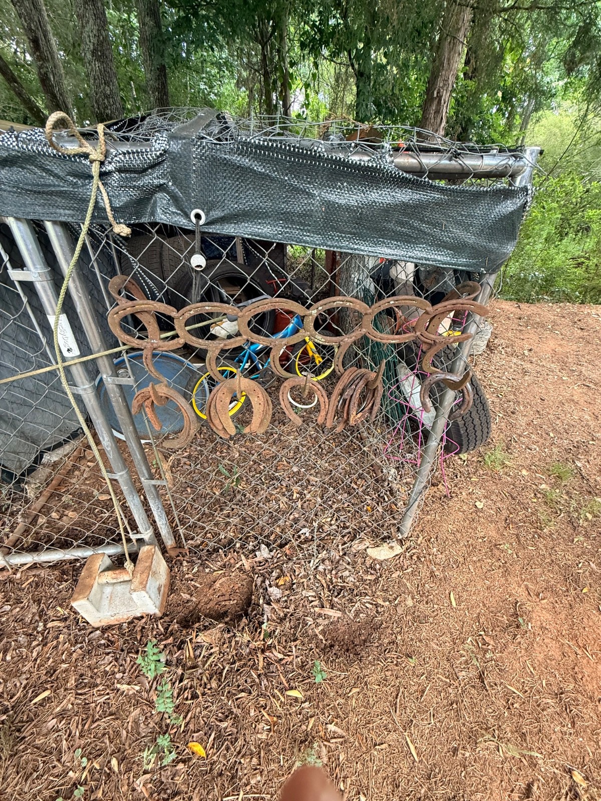 vintage farm implements equipment including horse shoes and an assortment of oth