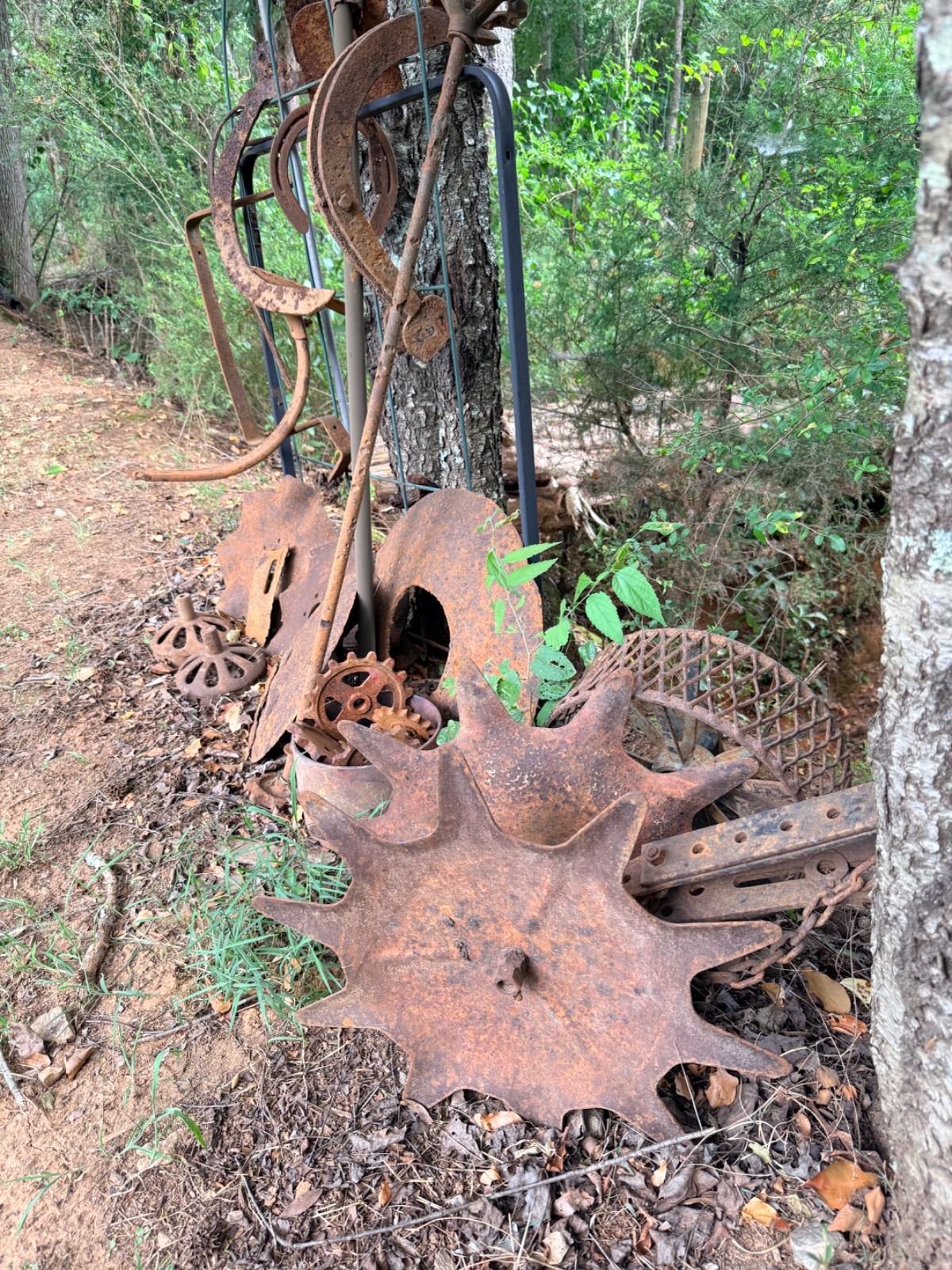 vintage farm implements equipment including horse shoes and an assortment of oth