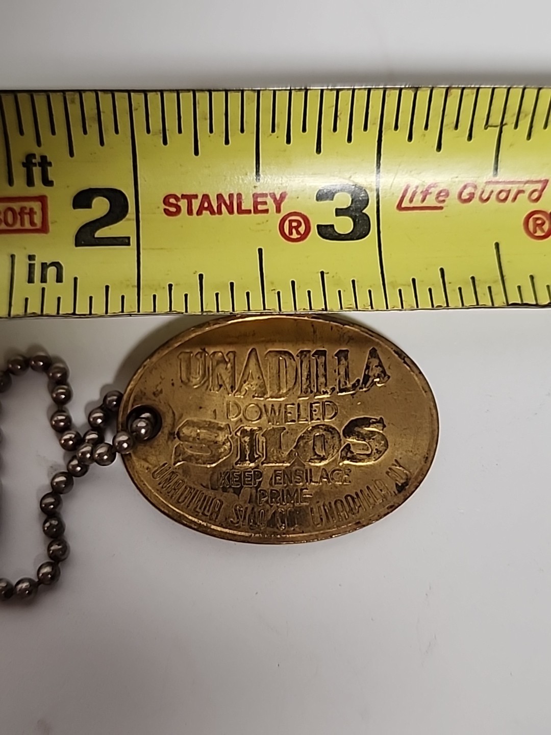 1906 ANTIQUE UNADILLA SILOS NY FARM ADVERTISING PENDANT KEYCHAIN CHARM FOB TAG