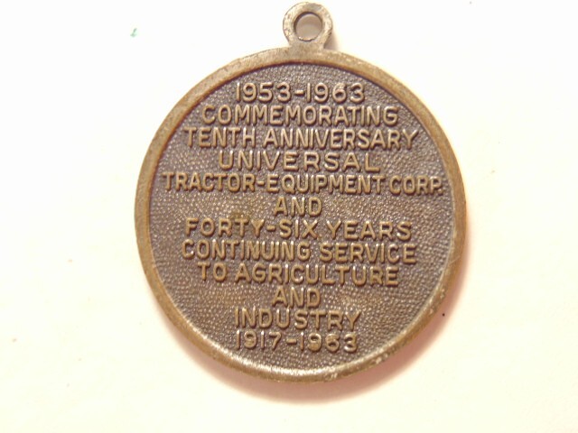 Universal Tractor Equipment Corp. 10th anniversary 1963 silver colored pendant