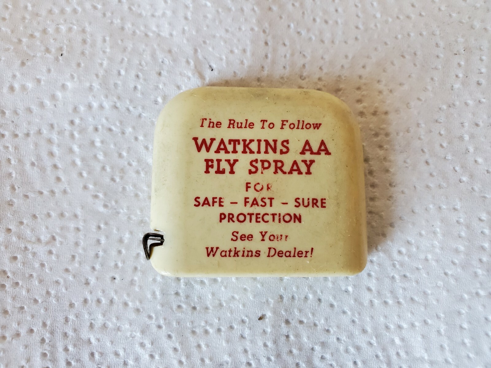 small plastic tape measure watkins AA fly spray see your watkins dealer