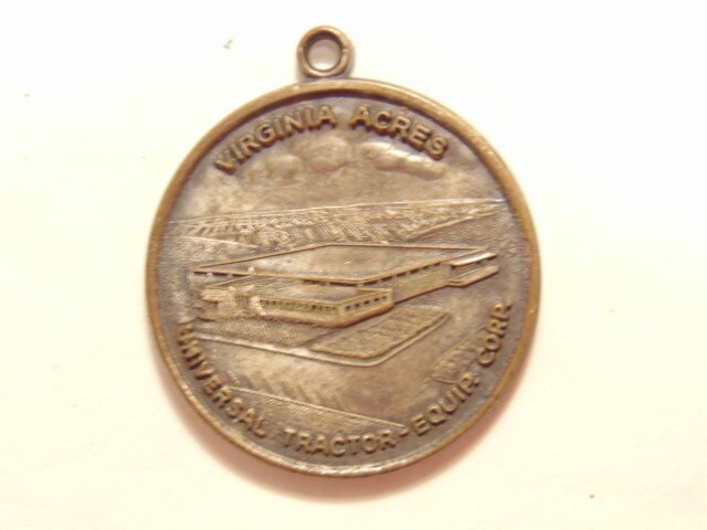 Universal Tractor Equipment Corp. 10th anniversary 1963 silver colored pendant
