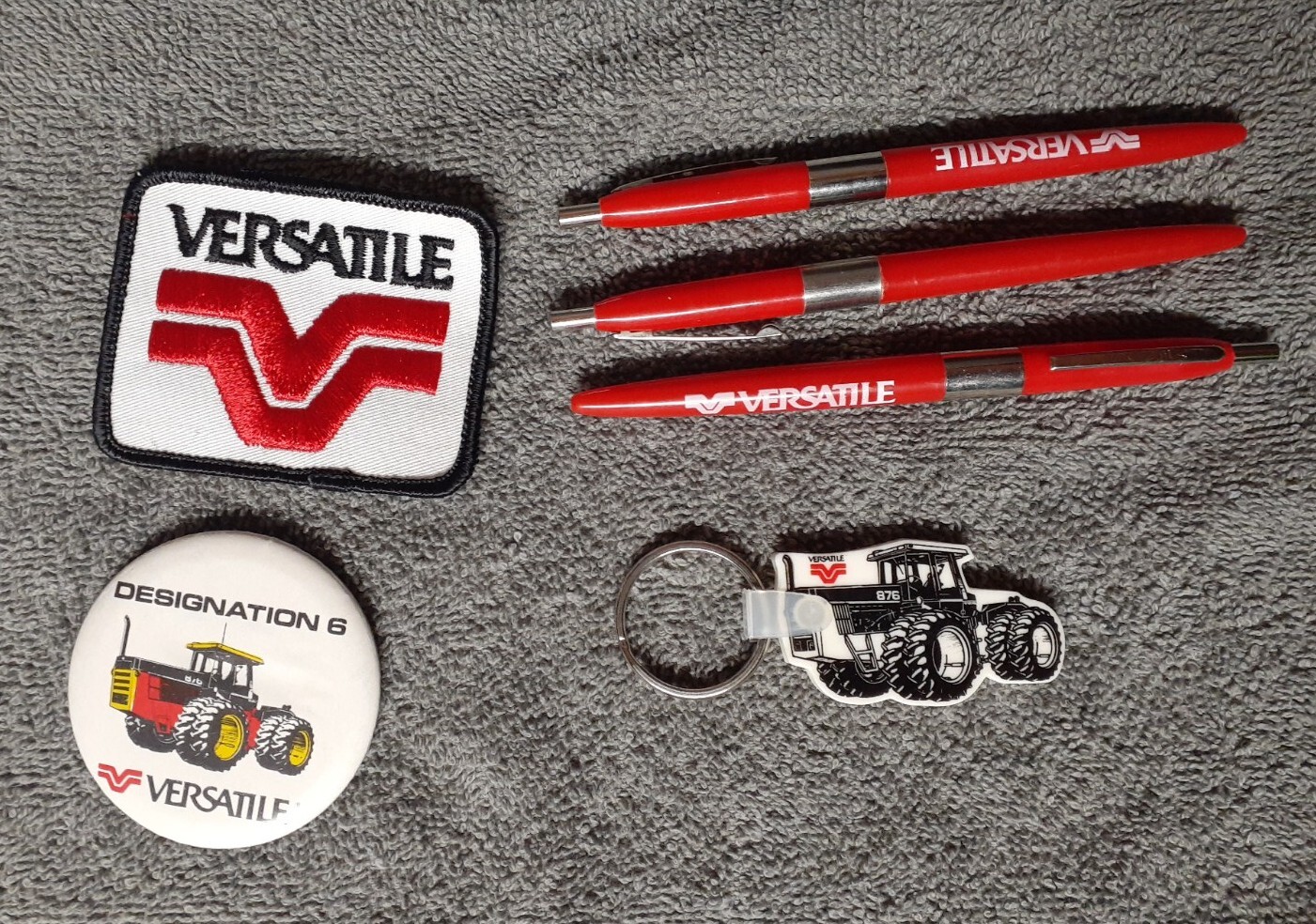 Versatile Tractor Collectibles – Iron-On Patch, Button Pin, Keychain and 3 Pens