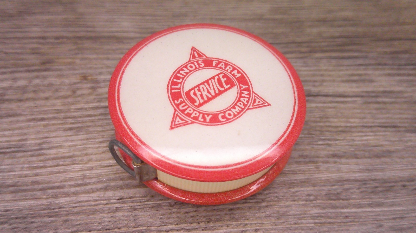 Illinois Farm supply co advertising celluloid tape measure has cloth tape works
