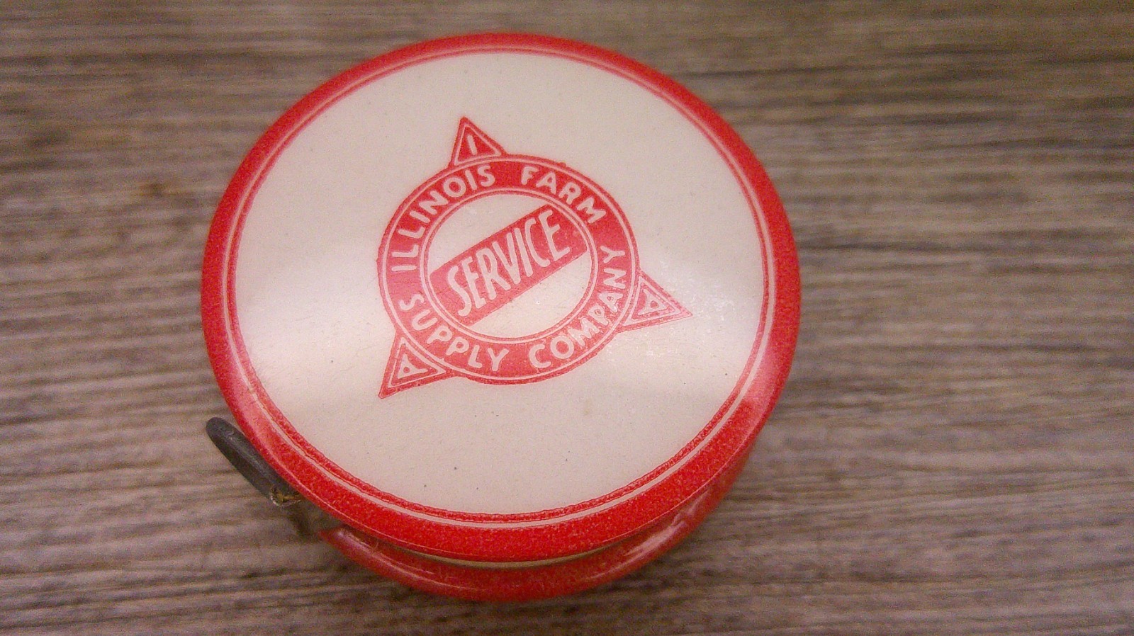 Illinois Farm supply co advertising celluloid tape measure has cloth tape works