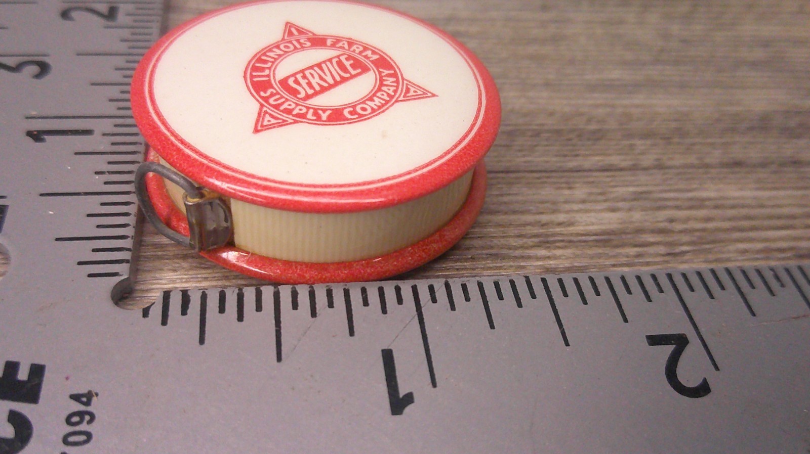 Illinois Farm supply co advertising celluloid tape measure has cloth tape works