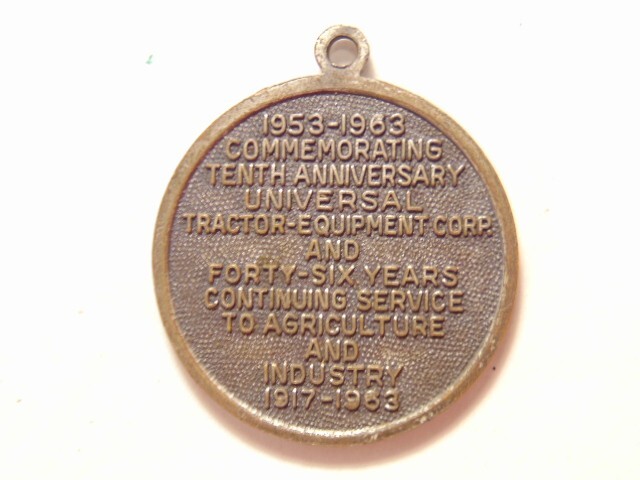Universal Tractor Equipment Corp. 10th anniversary 1963 silver colored pendant