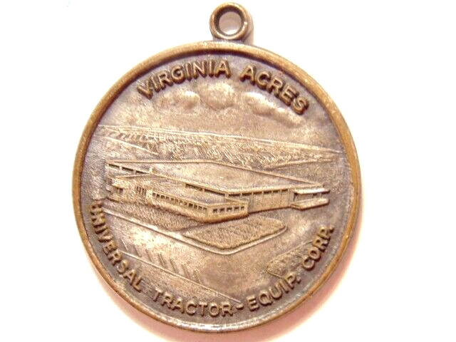 Universal Tractor Equipment Corp. 10th anniversary 1963 silver colored pendant