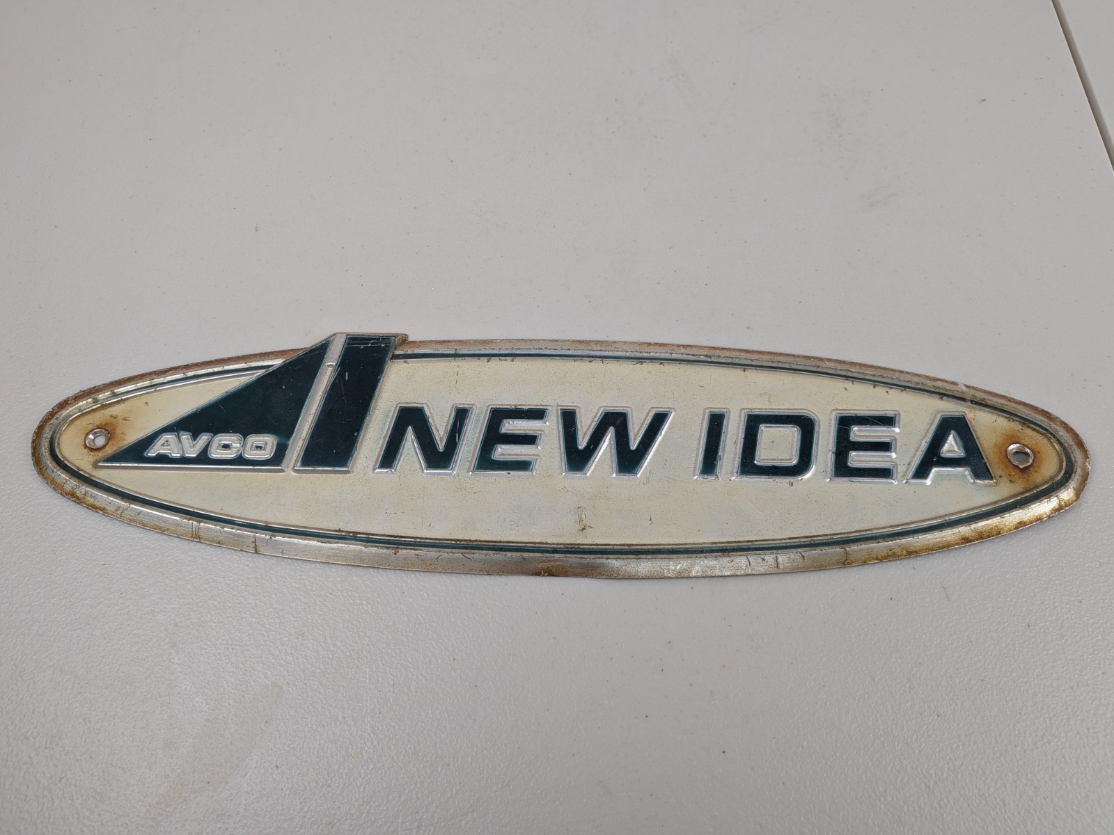 Vintage AVCO “New Idea” Sign/ Emblem 18&Prime; × 4 1/2&Prime; Fair Condition