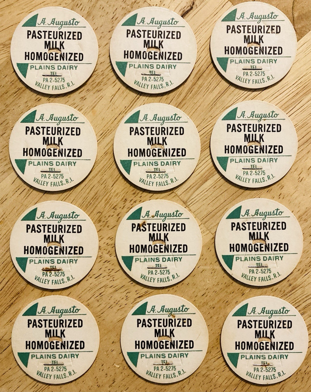 MILK BOTTLE CAP LOT OF (12)~PLAINS DAIRY, A. AUGUSTO, VALLEY FALLS, RI.